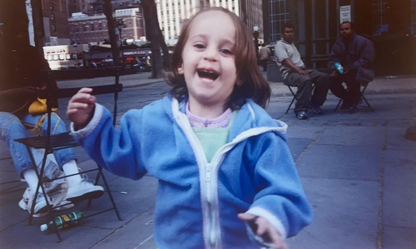 Sabina running in Bryant Park as a child